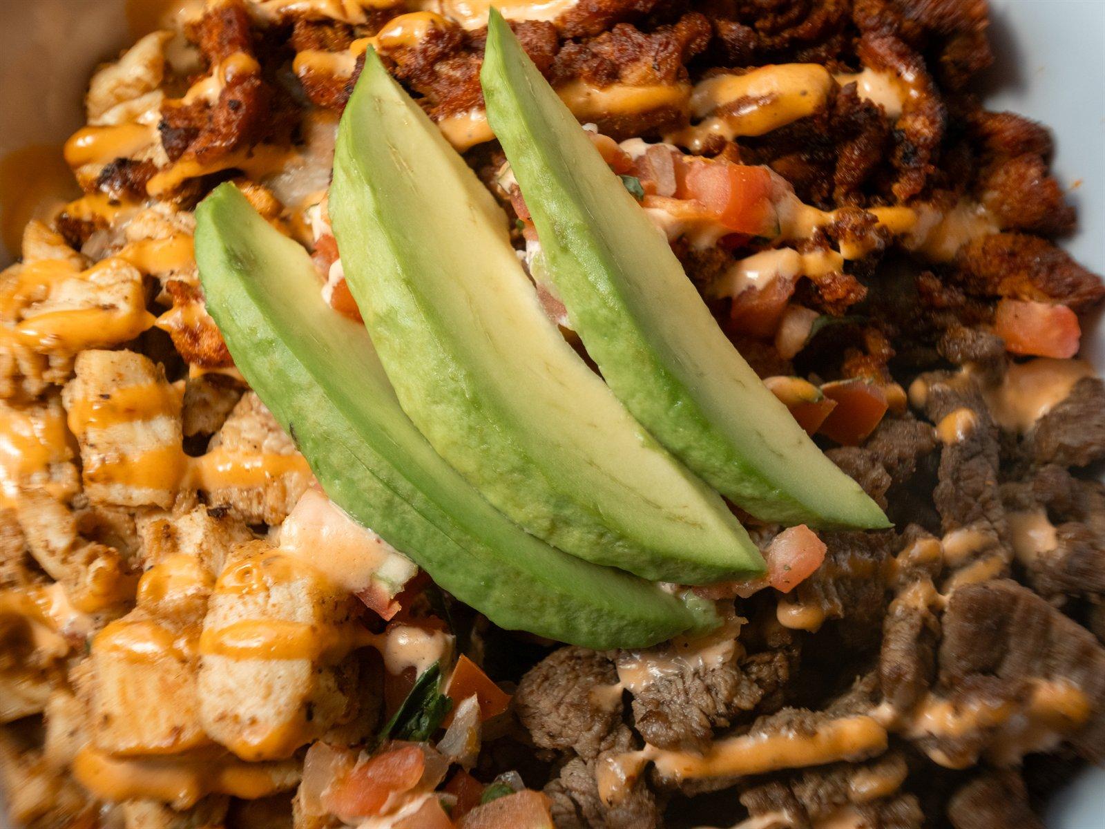 Loaded rice bowl topped with avocado slices