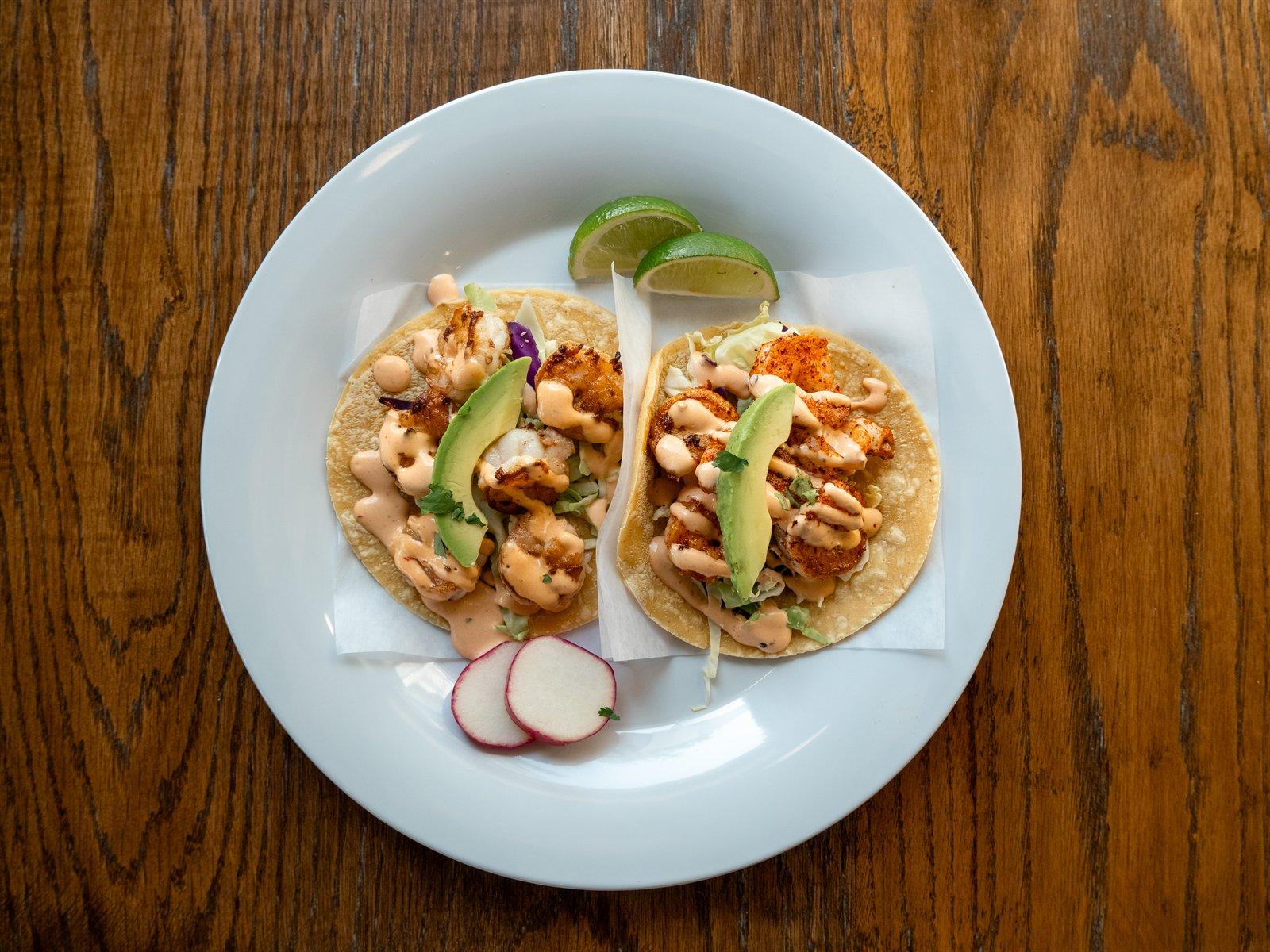 Shrimp tacos with slaw, avocado and crema