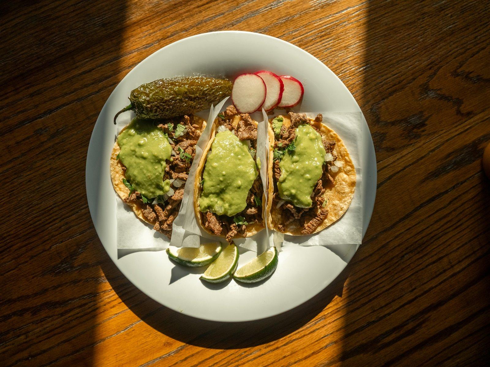 Plate of three street tacos from above